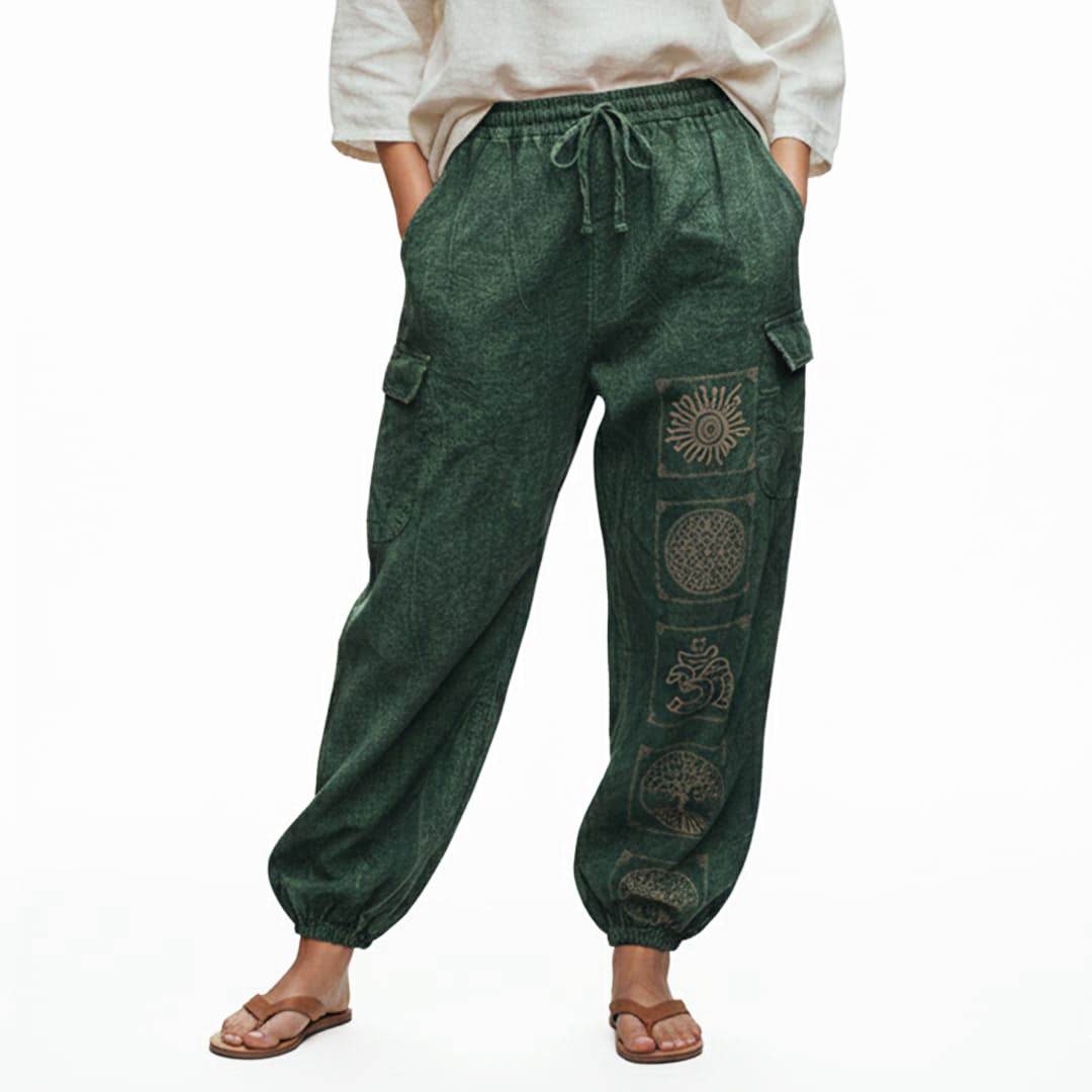Close-up detail of green stonewashed tribal mandala harem pants with handcrafted ethnic symbols and cargo pockets