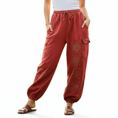 Close-up of red stonewashed tribal mandala harem pants focusing on the vibrant fabric and mandala prints.