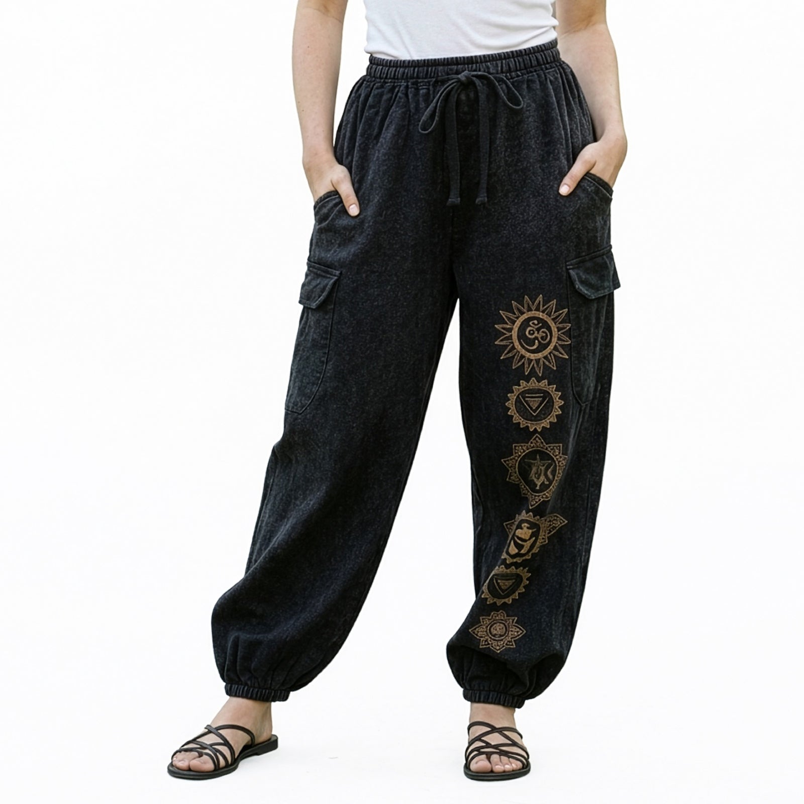 Close-up of black stonewashed tribal om harem pants highlighting the om prints and cargo pocket seams.