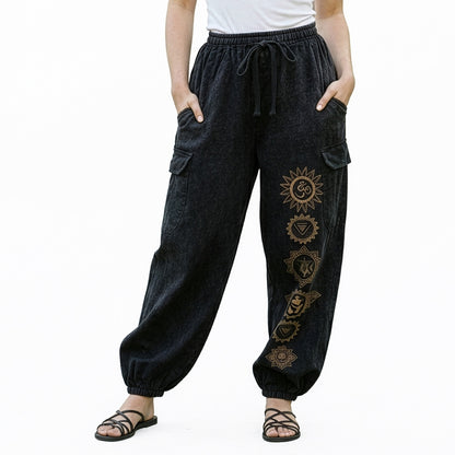 Close-up of black stonewashed tribal om harem pants highlighting the om prints and cargo pocket seams.