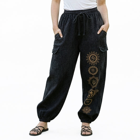 Close-up of black stonewashed tribal om harem pants highlighting the om prints and cargo pocket seams.