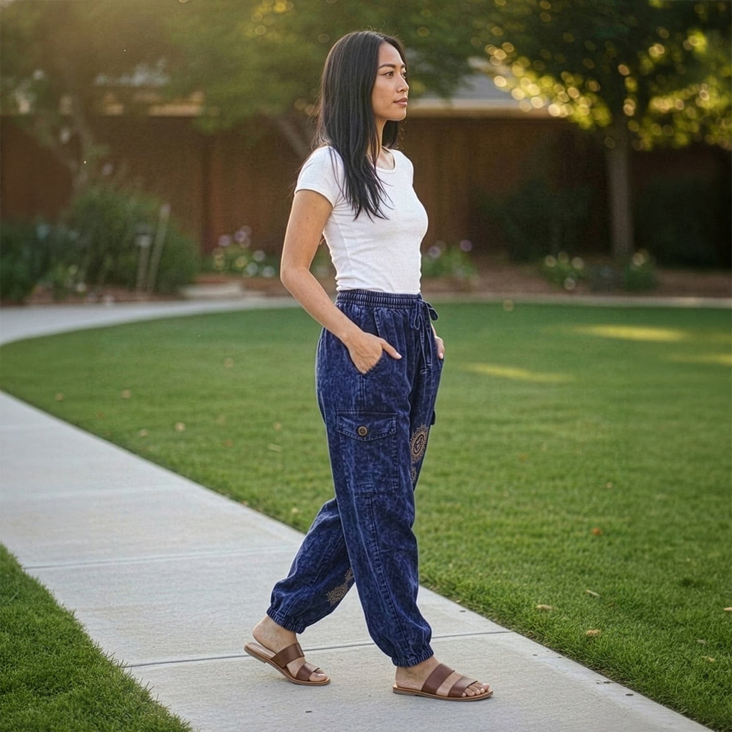Side view of blue boho stonewashed harem pants highlighting the stitched side cargo pocket.