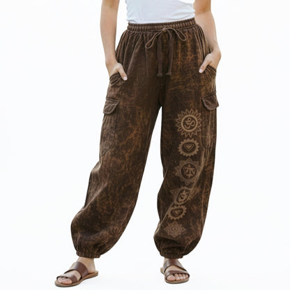 Close-up shot of brown stonewashed tribal om harem pants showing natural cotton and stitched cargo pockets.