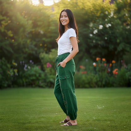 Side view of green boho stonewashed harem pants showing the relaxed silhouette and side pockets.