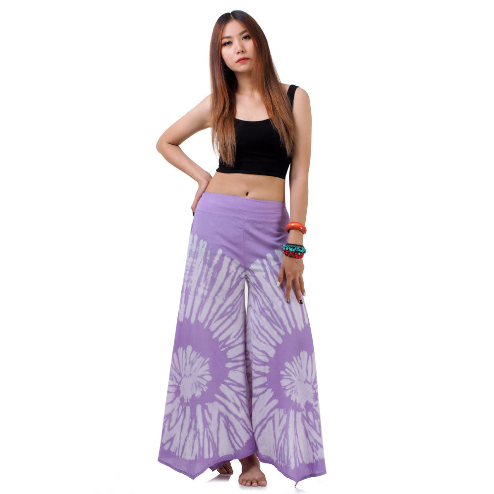 Side profile of the Vibrant Violet Hippie Tie Dye Palazzo Pants on a female model, showing the generous flare and graceful drape.
