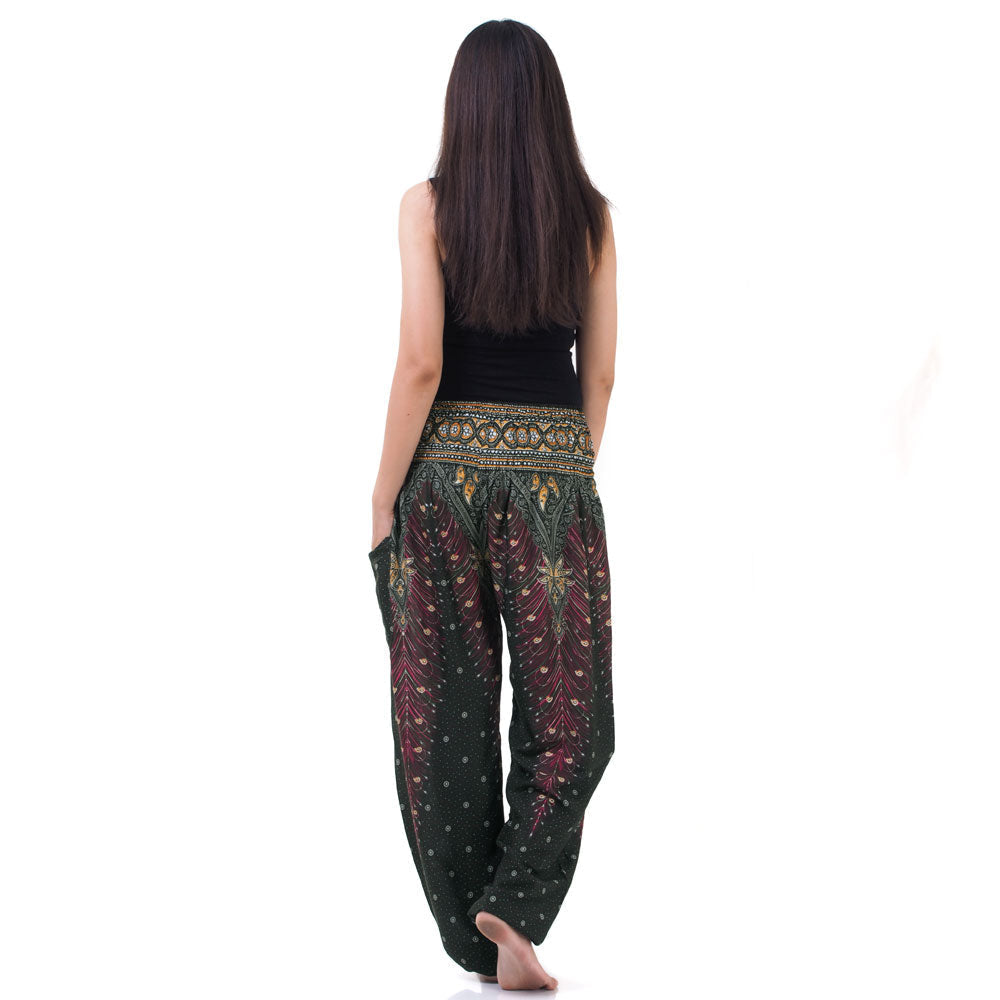 Back view of green Thai harem yoga pants with peacock print worn with black top