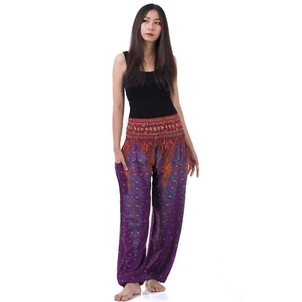 Model wearing purple Thai harem yoga pants with peacock print and black top, front view