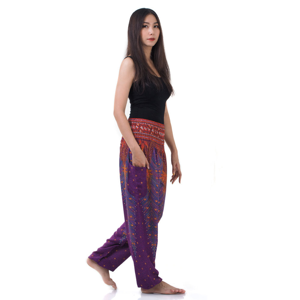 Side view of model in purple Thai harem yoga pants with peacock print and black top