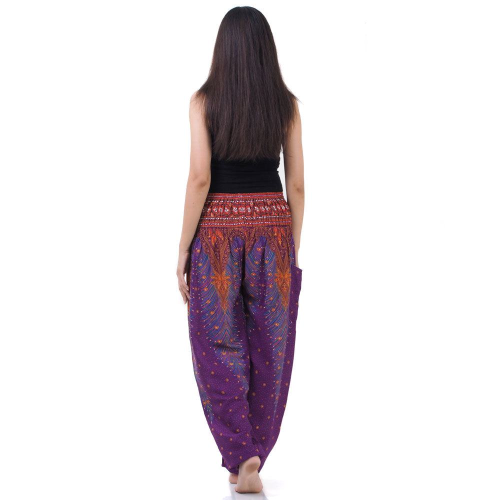 Back view of purple Thai harem yoga pants with peacock print worn with black top