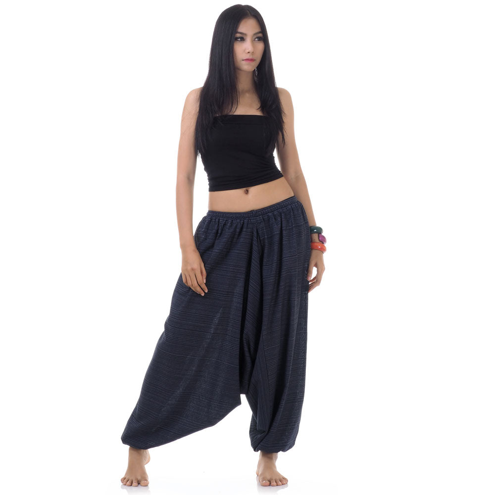 Model wearing blue women pinstripe drop crotch thai harem pants with black top, front view