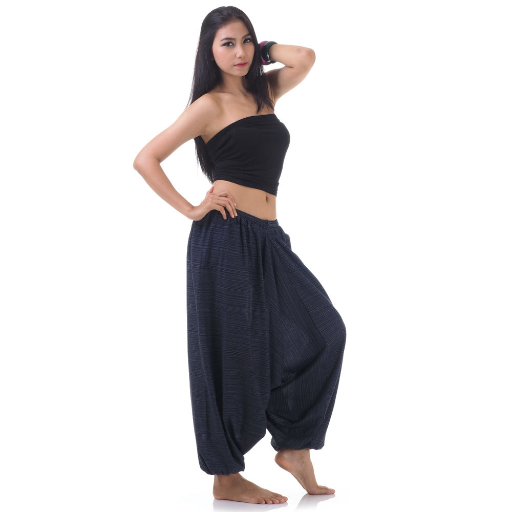 Side view of model in blue women pinstripe drop crotch thai harem pants with black top