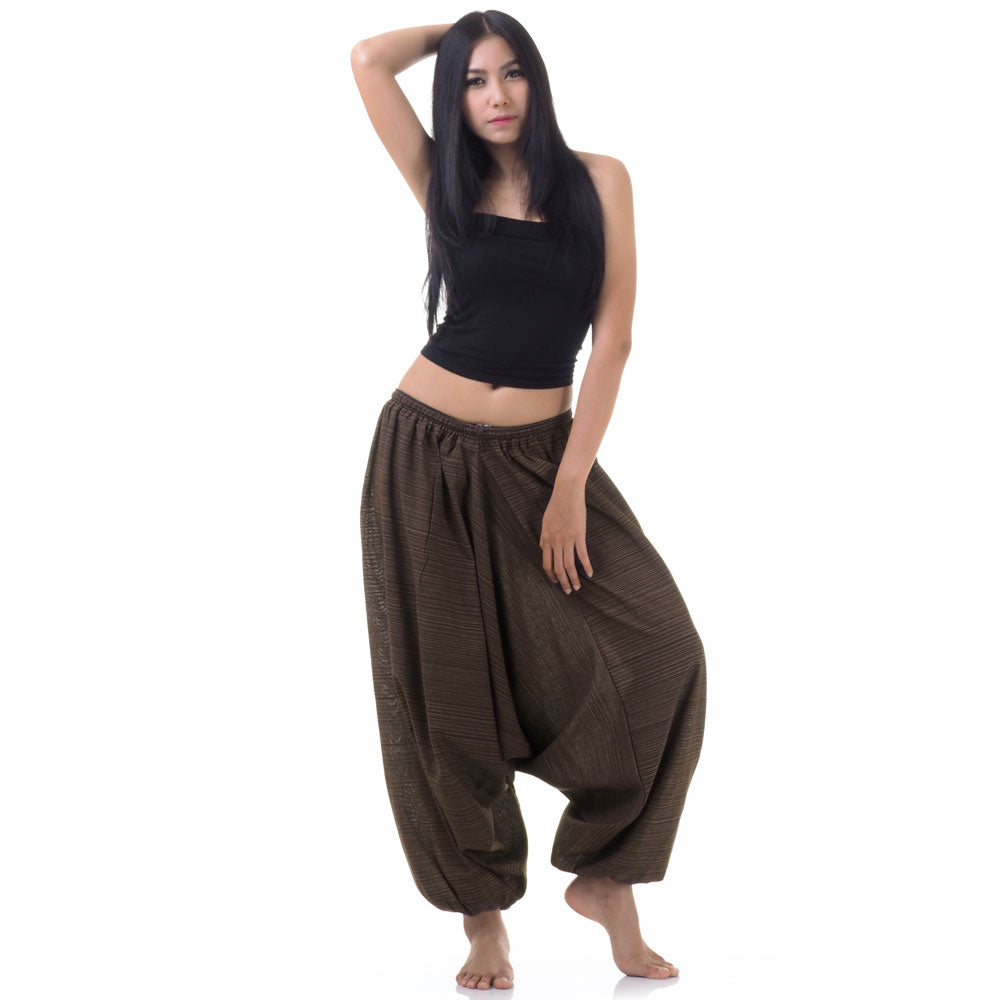 Model wearing brown women pinstripe drop crotch thai harem pants with black top, front view