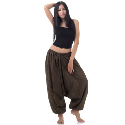 Model wearing brown women pinstripe drop crotch thai harem pants with black top, front view