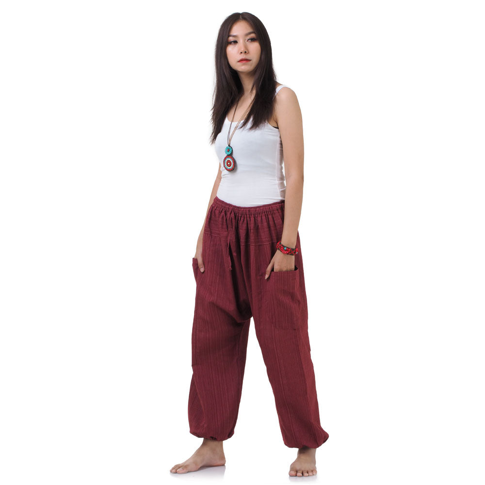 Side profile of the Sunset Maroon harem pants, showing the relaxed fit and cotton texture.