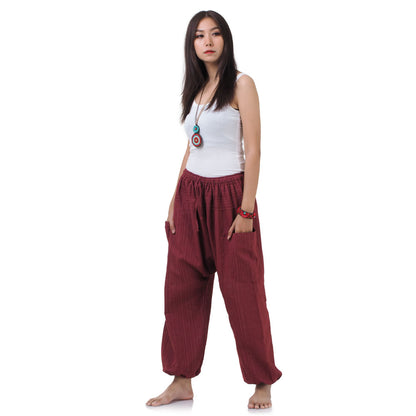Side profile of the Sunset Maroon harem pants, showing the relaxed fit and cotton texture.