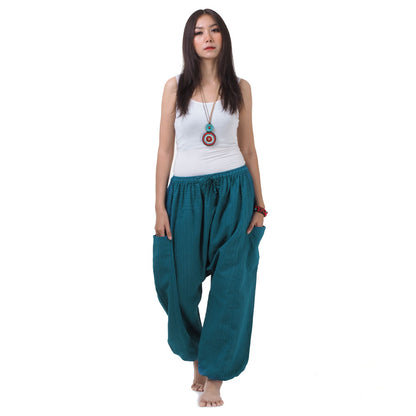 Front view of the Women's Pinstripe Harem Pants Turquoise Bay, featuring a comfortable elastic waistband and two convenient pockets.