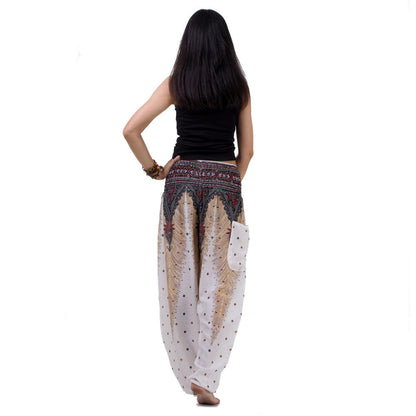 Back view of white Thai harem yoga pants with peacock print worn with black top