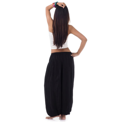 Back view of a female model wearing midnight black Thai pants, comfortable free-moving fit S-M.