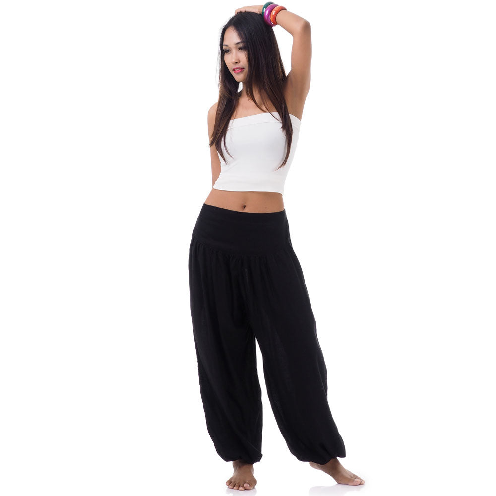 Front view of a female model wearing midnight black Thai harem pants, unique artisan clothing.