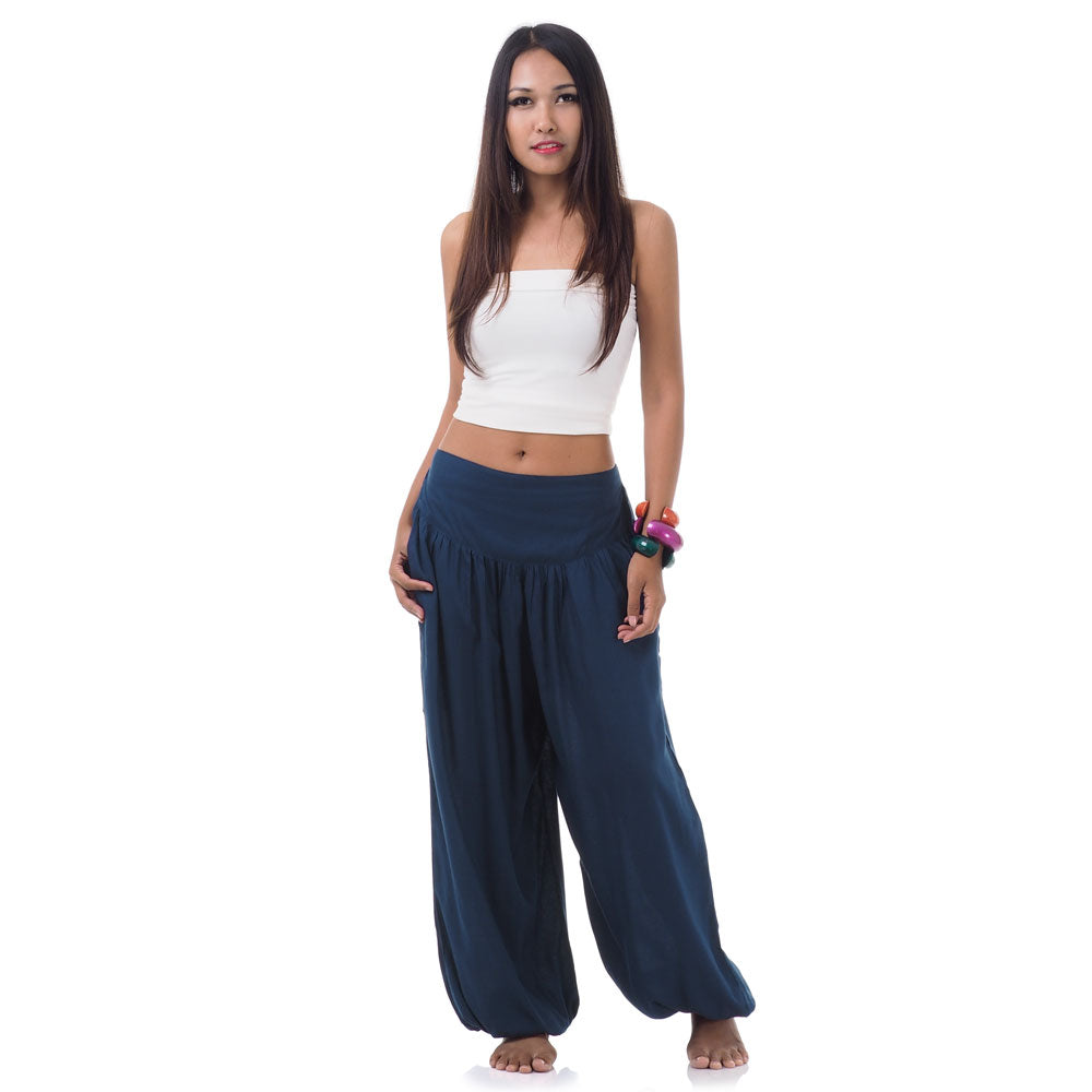 Front view of a female model wearing moonlight blue Thai harem pants, sophisticated boho style.