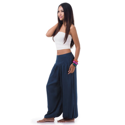 Side view of a female model in moonlight blue boho pants showcasing the elastic cuffs.