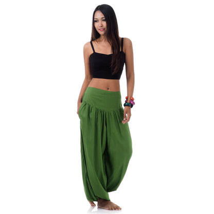 Front view of a female model wearing emerald oasis Thai harem pants, unique artisan clothing.