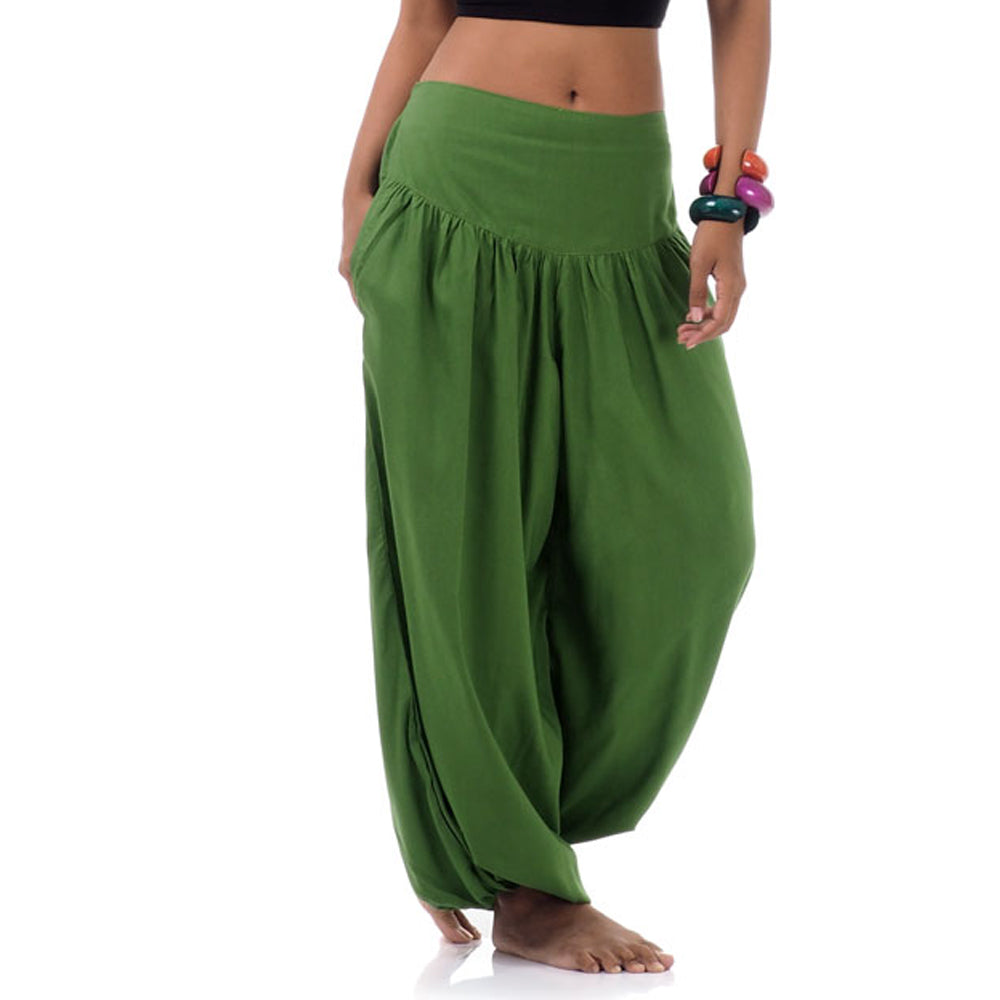 Close-up emerald oasis Thai harem pants, vibrant handcrafted solid green color.