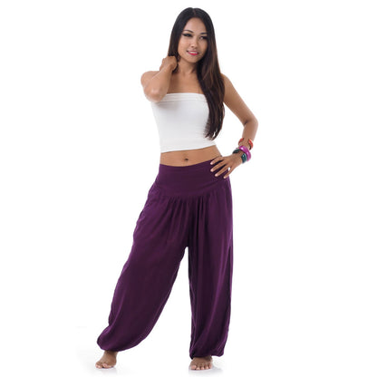 Front view of a female model wearing purple orchid Thai harem pants, handcrafted sophistication.