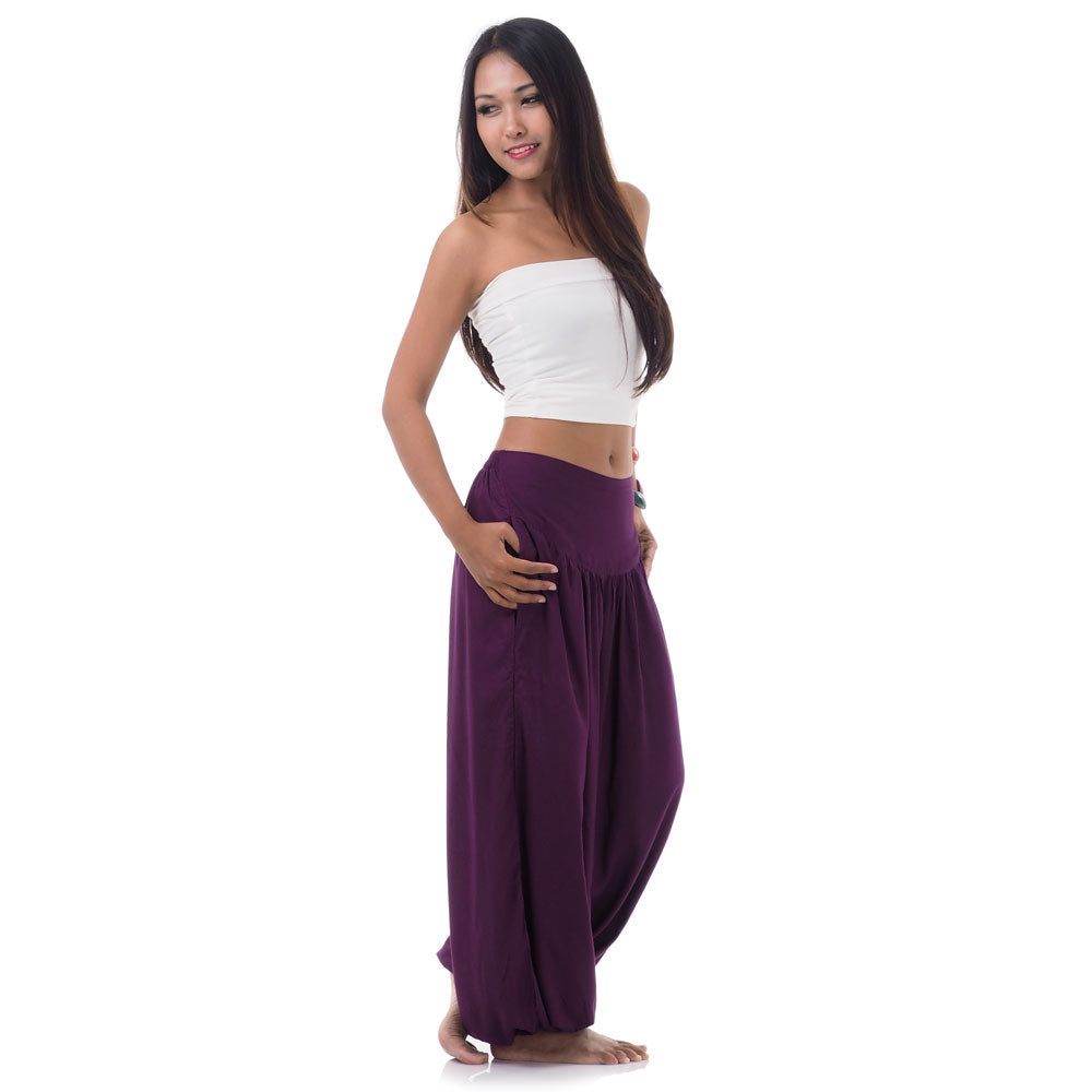 Side view of a female model in purple orchid boho pants highlighting the two convenient pockets.