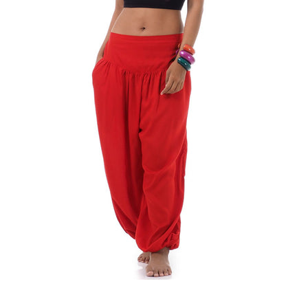 Close-up sunset red Thai harem pants, warm handcrafted solid color.