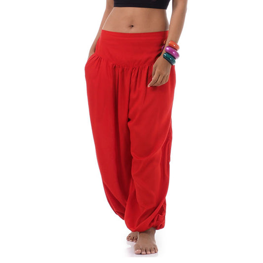 Close-up sunset red Thai harem pants, warm handcrafted solid color.
