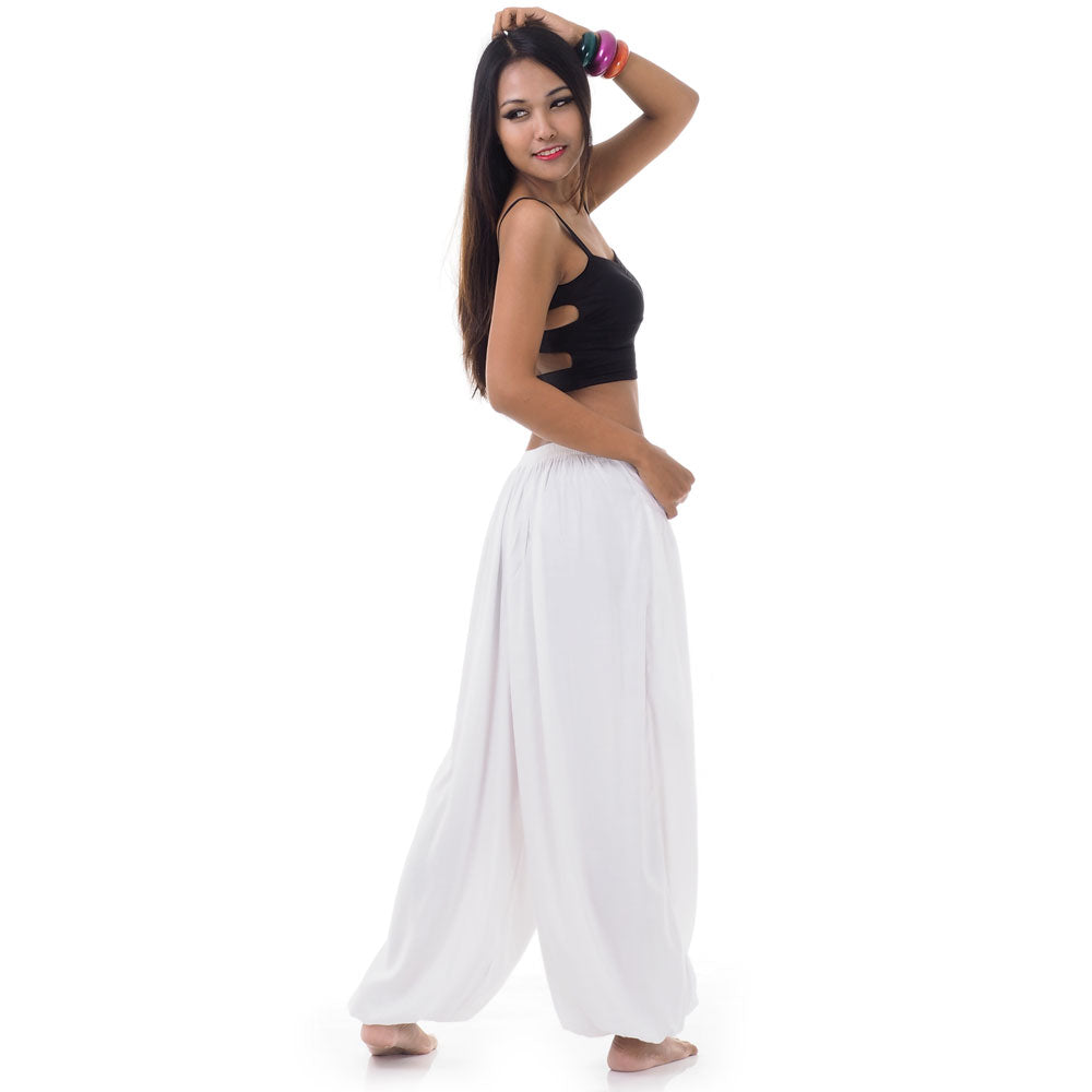 Back view of a female model wearing sunny white Thai pants, elasticated hips and ankles.