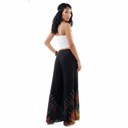 Side view of the Midnight Magic Hippie Tie Dye Palazzo Pants on a female model, illustrating the elegant flare and movement.