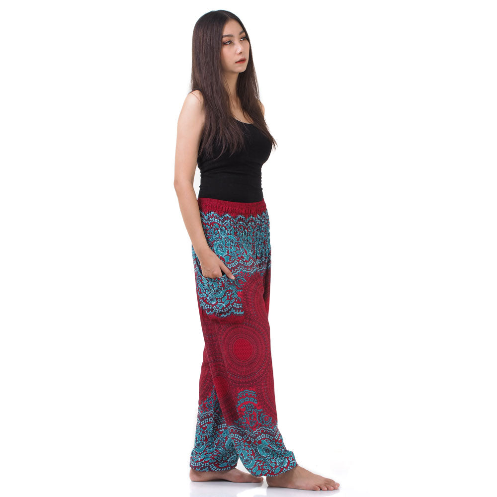 Side view of model in red Thai harem yoga pants with mandala print and black top