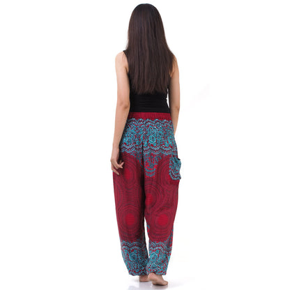 Back view of red Thai harem yoga pants with mandala print worn with black top