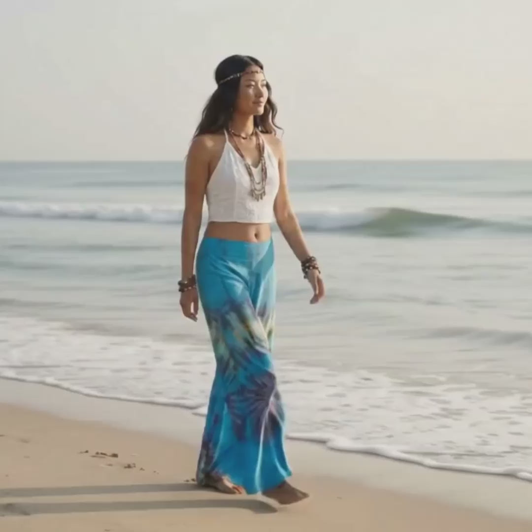 Video: Female model strolling leisurely on a sandy Thai beach wearing the light Ocean Blue Hippie Tie Dye Palazzo Pants.