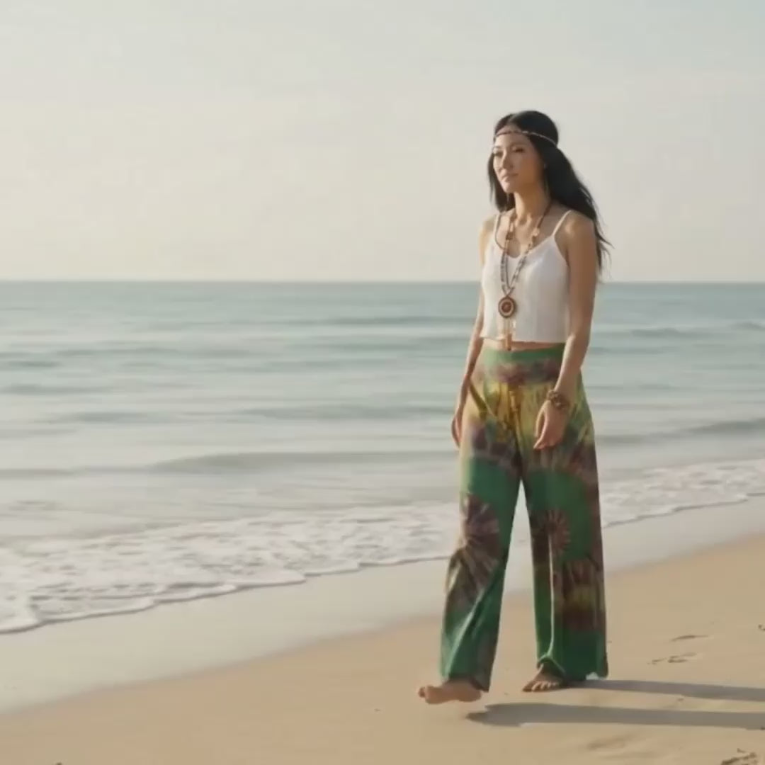 Video: Female model strolling along the tropical sandy Thai beach wearing the breezy Emerald Oasis Hippie Tie Dye Palazzo Pants.