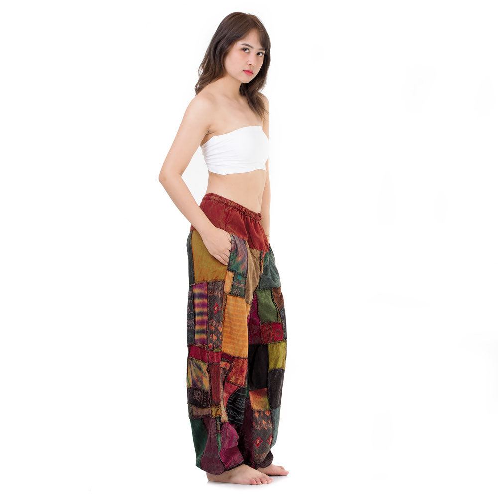 Side view of model in multicolored patchwork Thai harem yoga pants and white top