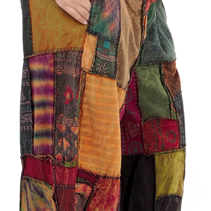Colorful patchwork harem pants with various patterns and textures on a white background