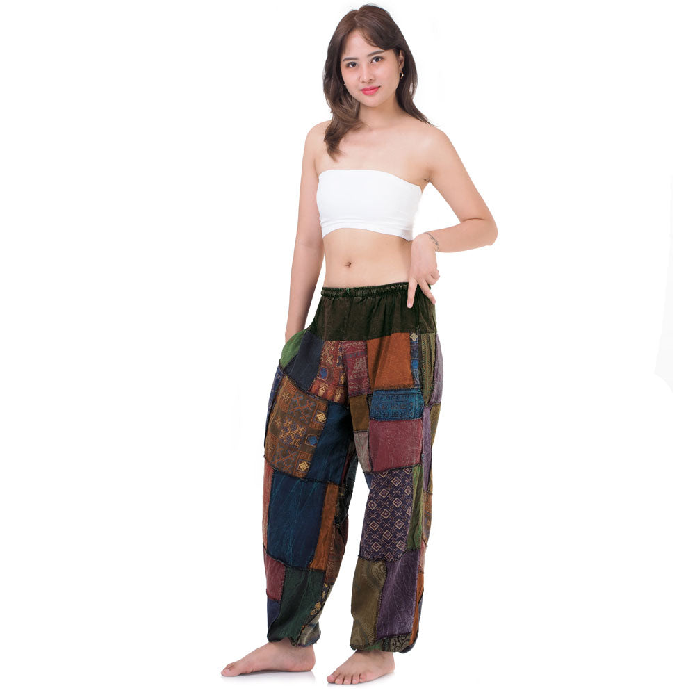 Model wearing multicolored patchwork Thai harem yoga pants and white top, front view
