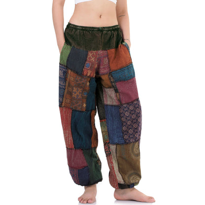 Close-up of a multicolored Thai patchwork harem pants worn by a person on a white background